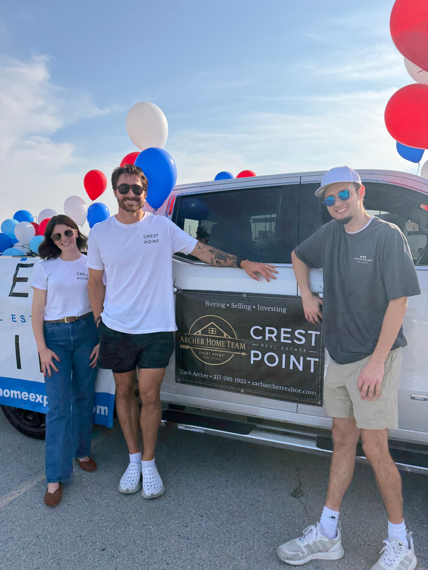 Archer Home Team and Crest Point Real Estate team members in branded shirts beside a truck with a community-event bed banner in Hendricks County, Indiana